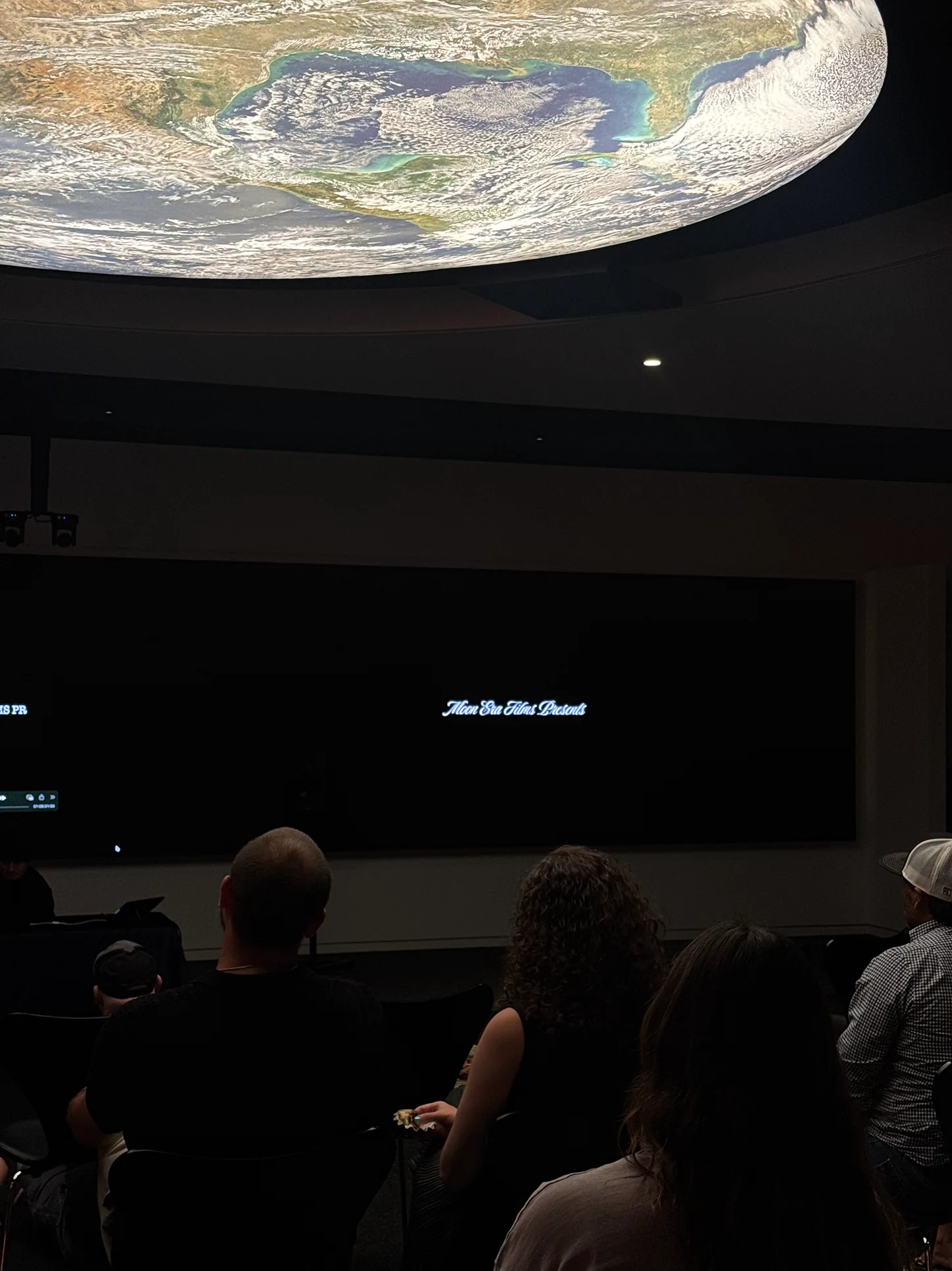 Audience watching the Moon Era Films presentation during the 2025 screening event